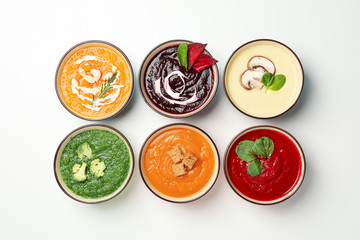 Vegetable soups on white background, top view. Healthy eating
