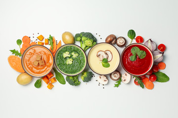 Vegetable soups and ingredients on white background, top view