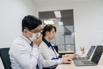 Businessman is working in office. He is having sick.