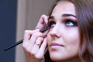 Makeup artist paints a girl