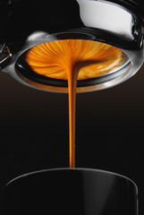 Espresso shot from espresso machine dark background