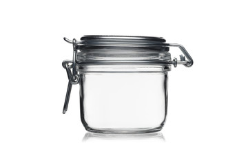 Empty glass jar for food storage isolated on a white background.