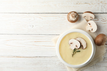 Mushroom cream soup on wooden background, top view