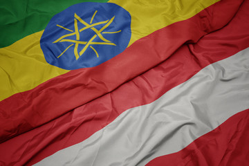 waving colorful flag of austria and national flag of ethiopia .