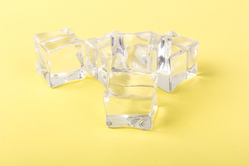 ice cubes in close-up on yellow background