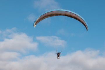 Paraglider with instructor pilot in tandem in the sky