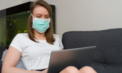 Woman in medical mask working from home. Isolation at home.