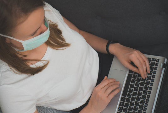 Woman in medical mask working from home. Isolation at home.