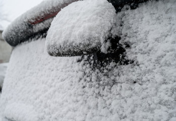 Car covered by snow at winter.