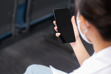 A girl and Black screen smartphones in hand