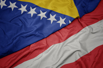waving colorful flag of austria and national flag of bosnia and herzegovina.
