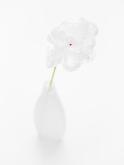 Plastic nylon flower in plastic vase