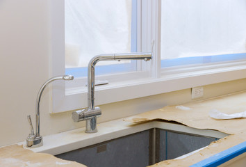 Interior of modern kitchen with appliances on stove top, counter with kitchen cabinets