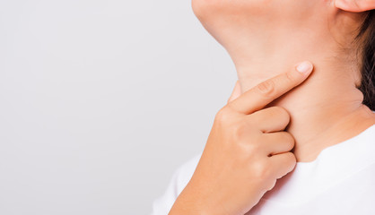 Asian beautiful woman Sore Throat or thyroid gland problem her useing Hand Touching Ill Neck