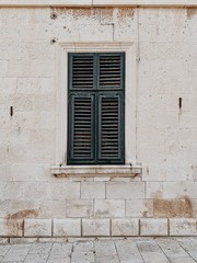 Fototapeta na wymiar Minimal travel concept. Green wood shutters on old building. Front view. Old town and architecture in Europe,, Croatia, Dubrovnik.
