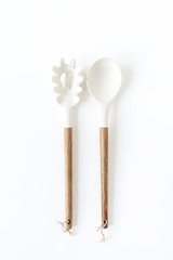 Salad serving utensils set. Spoon and fork on white background. Minimal kitchenware concept.