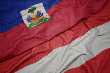 Fototapeta premium waving colorful flag of austria and national flag of haiti.
