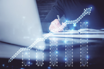 Double exposure of businessman with laptop and stock market forex chart.
