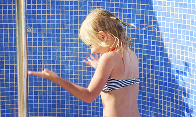Little girl having fun time in the Swimming pool, Summer time, Vacation