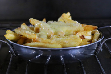 deep fried french fries with melted cheddar cheese, known as cheesy fries