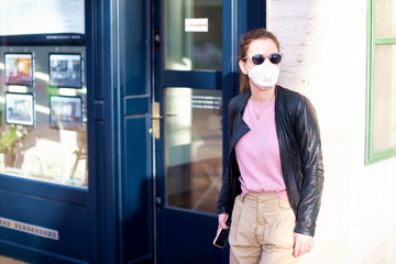 Confident young woman wearing face mask while standing outdoor during virus outbreak