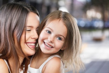 Happy smiling mother and daughter hugging