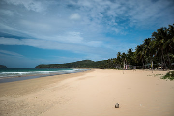 Fototapeta na wymiar Empty and remote beach on a sunny summer day