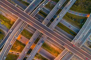 Obraz premium The light on the road roundabout at night and the city in Bangkok, Road beautiful Aerial View of Busy Intersection, Aerial view. Top view. Background scenic road.