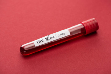 positive hiv blood sample test on red background - obrazy, fototapety, plakaty