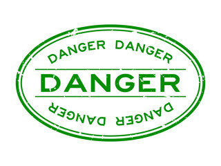 Grunge green danger word oval rubber seal stamp on white background