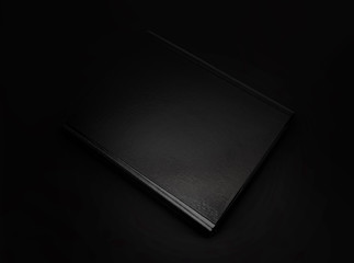Black leather folder isolated on black background