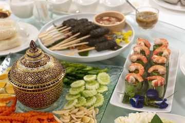 Porcelain cups, boiled eggs, carrots, ginger, along with salad rolls. Traditional Thai food.