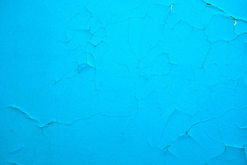 Cracked paint on the wall. Blue. Textura, destruction, paint flaking.