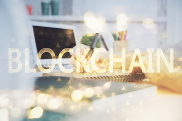 Cryptocurrency hologram over hands taking notes background. Concept of blockchain. Multi exposure