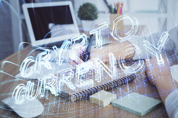 Cryptocurrency hologram over hands taking notes background. Concept of blockchain. Multi exposure