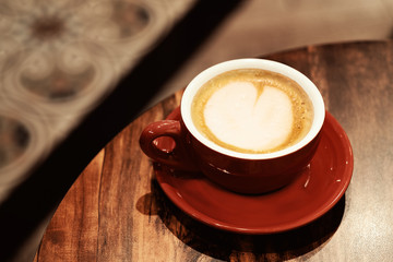 cappuccino cup on the brown wooden table
