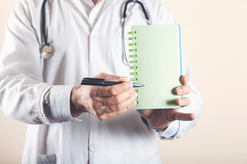 doctor writes notes on the clipboard in the hospital