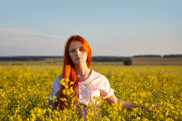 Fototapeta premium sexy redhead woman outdoors. Beautiful stylish romantic young girl in yellow field.