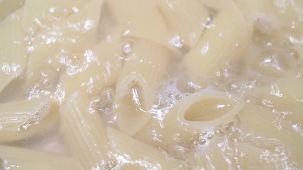 Italian Penne pasta in boiling water, just about al dente and ready to serve. 