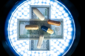 Color medicine pills on blue laboratory table