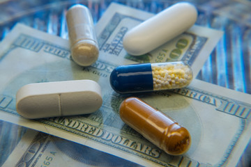 Color medicine pills on blue laboratory table