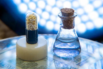 Test tubes and medicine pills on blue laboratory background