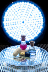 Test tubes and medicine pills on blue laboratory background