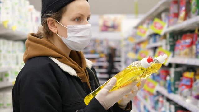Coronavirus Panic: Female Shopper Stocking Up On Essential Items. Woman At Supermarket With Mask.