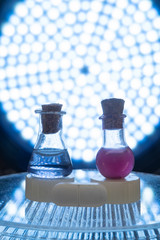 Test tubes and medicine pills on blue laboratory background
