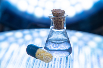 Test tubes and medicine pills on blue laboratory background