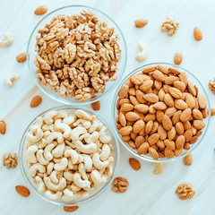 nuts in glass plates on the table, healthy food concept