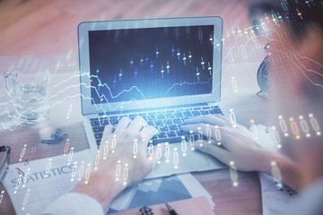 Multi exposure of forex graph with man working on computer on background. Concept of market analysis.