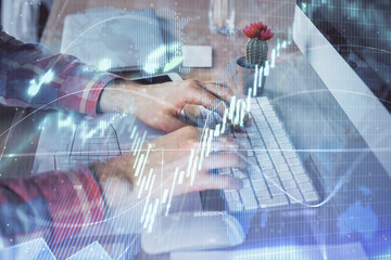 Double exposure of stock market chart with man working on computer on background. Concept of...
