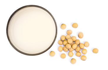 Soy beans and glass of soy milk isolated on white background. Top view. Flat lay.